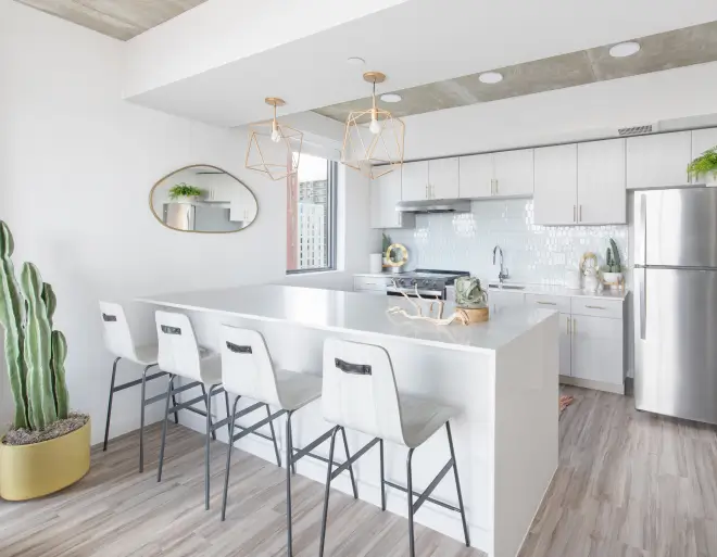 an apartment kitchen with stainless steel appliances